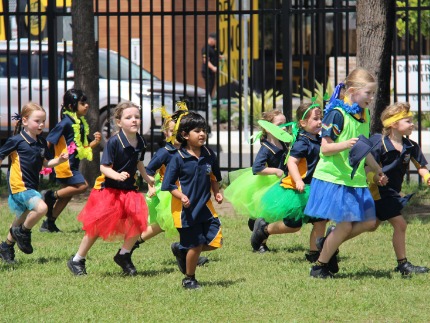 Yr 6 students running with prep kids at cross country