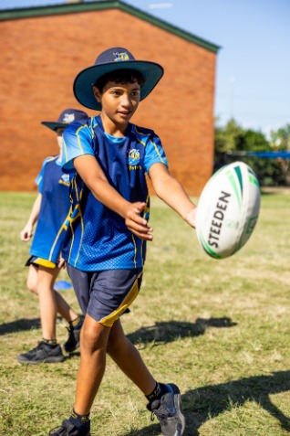 student catching rugby league ball